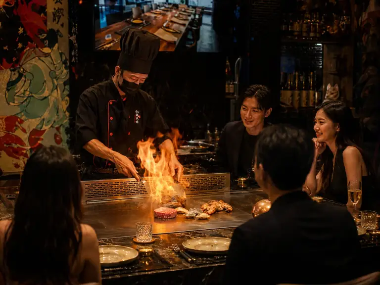 A Teppanyaki chef cooking in front of guests